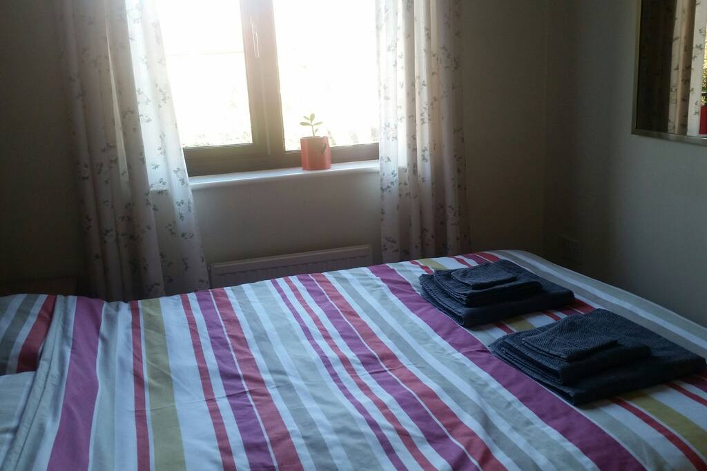 Bedroom 2 with a double bed overlooking the back garden