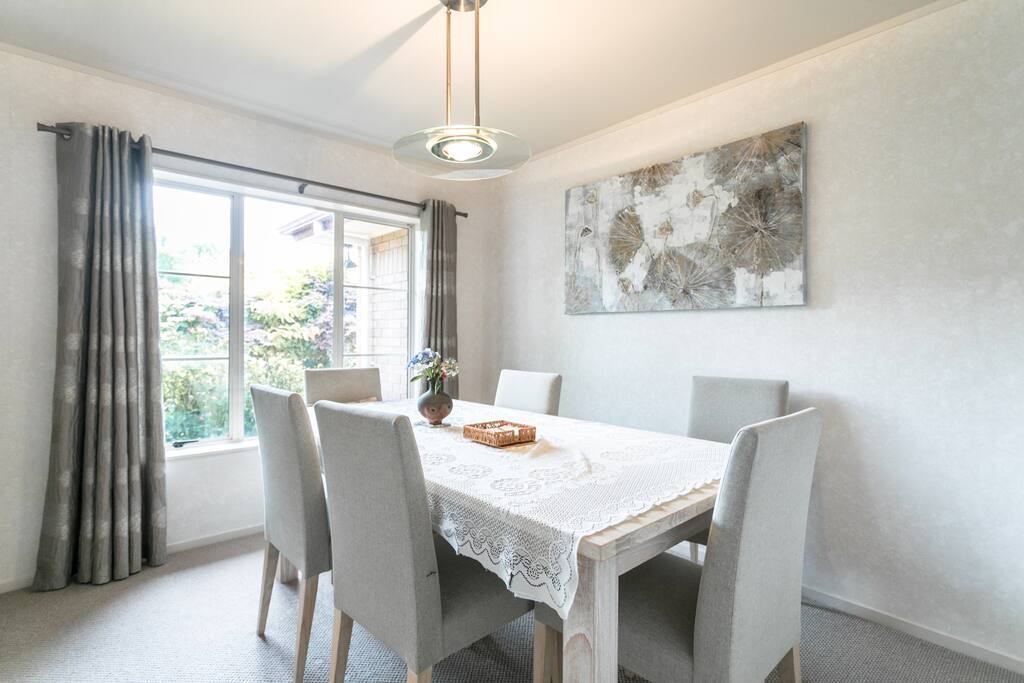 Formal dining room looking out to lovely gardens.