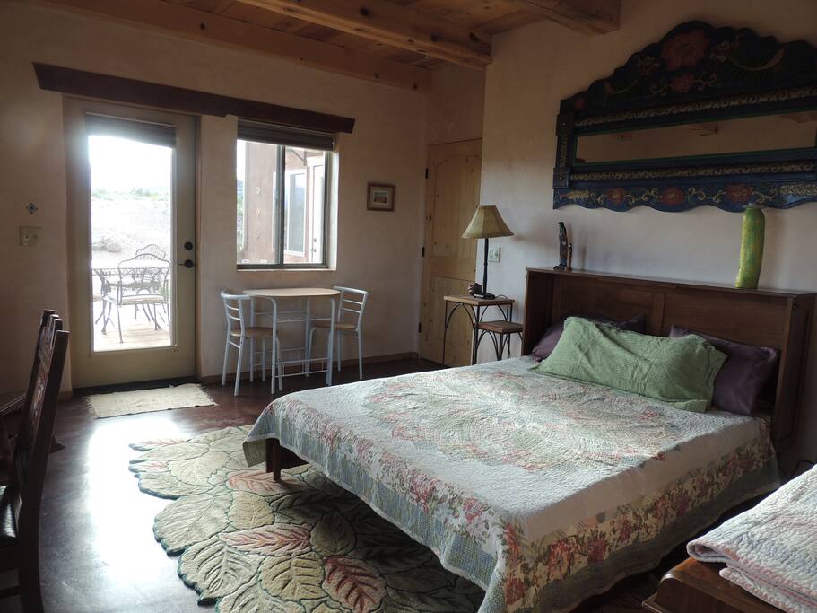 Bedroom has small table and two chairs.