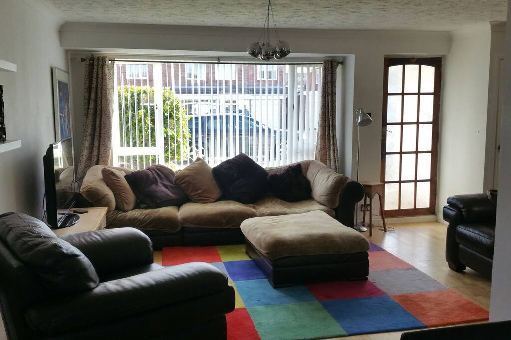 A light comfortable living area with plenty of sofas and a large tv with sky and free WiFi