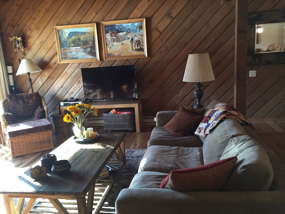 Plenty of seating for family and friends in sun drenched living room.