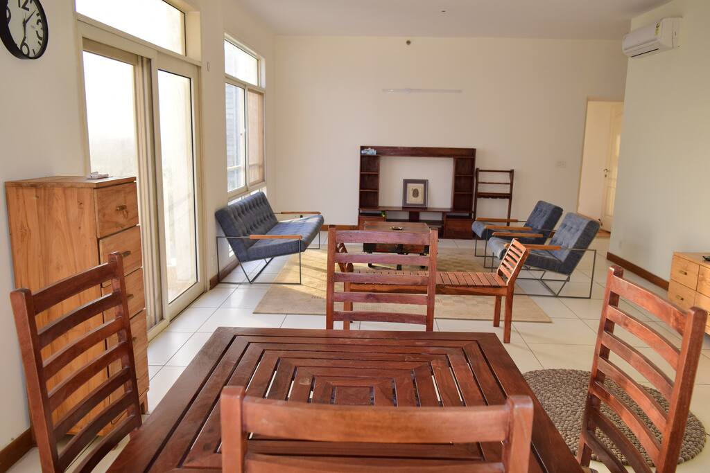 The spacious living room with glass view of indias best gold course