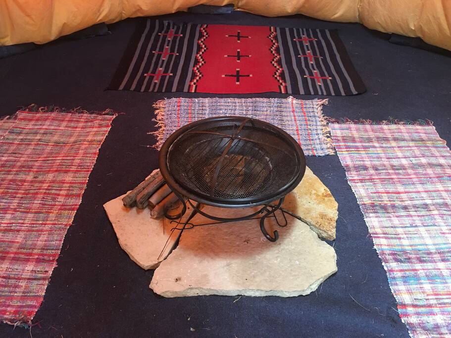 The tipi can sleep 6 adults to 10 kids. The floor is a layer of sand, plastic, carpets and rugs. Cots and air mattresses can be used. The fire ring can be moved as necessary. Fires are allowed in the tipi if the smoke flaps are open.