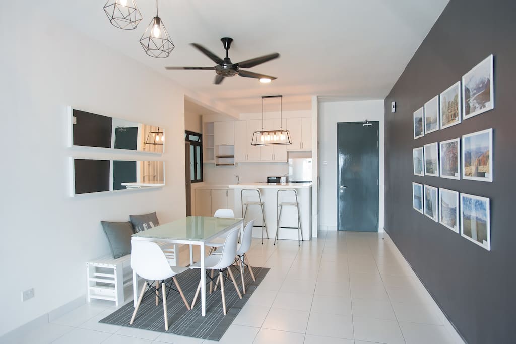 Bright open kitchen / dining area. Our travel wall shares photos we've taken on our travels over the years!