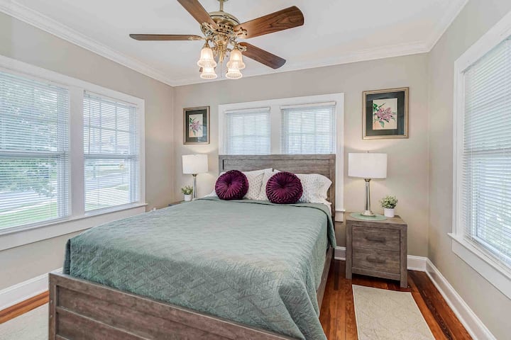 Enjoy a cheerful queen-sized bed room upstairs, offering views of both the front and back. This inviting space is perfect for relaxation and comfort.