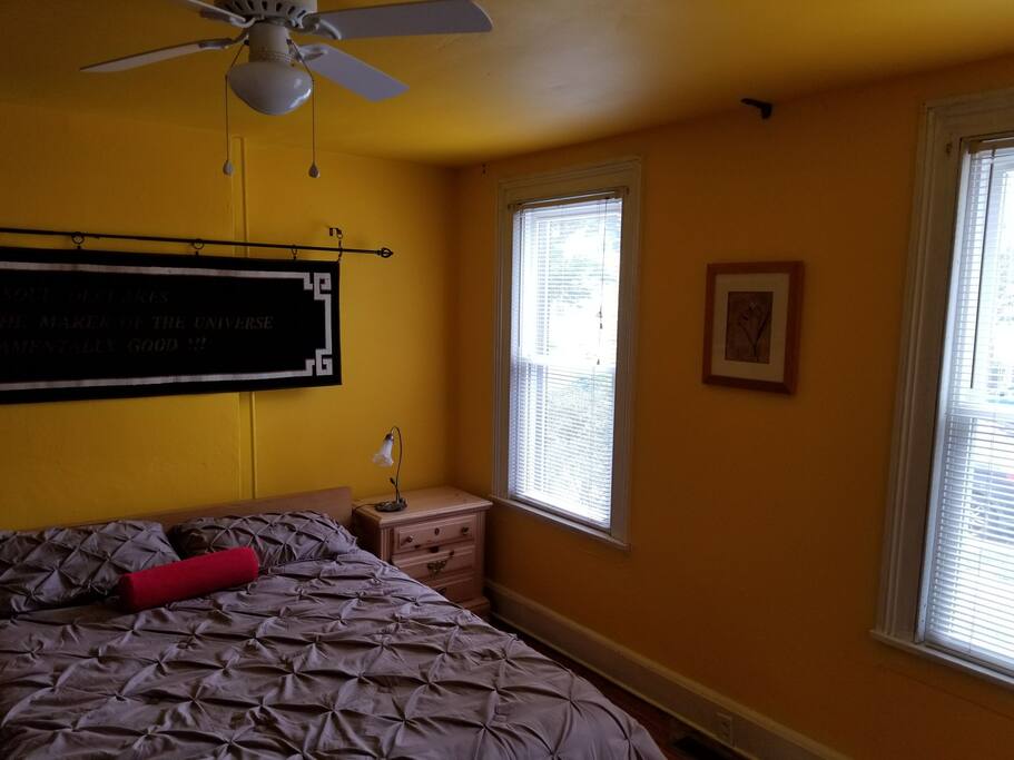 Bedroom has ceiling fan and two night stands, 2 lamps, ample lighting for reading