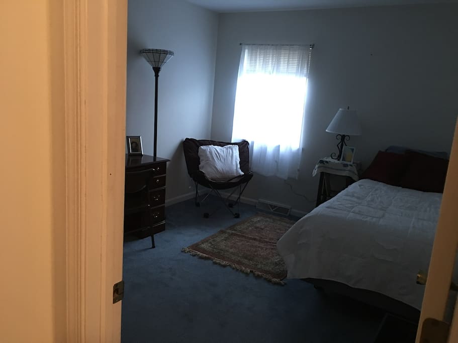This is the private bedroom with a single twin bed, a comfortable chair, a desk, a chair for the desk and a closet with hangers. Your private bath is right across your bedroom.