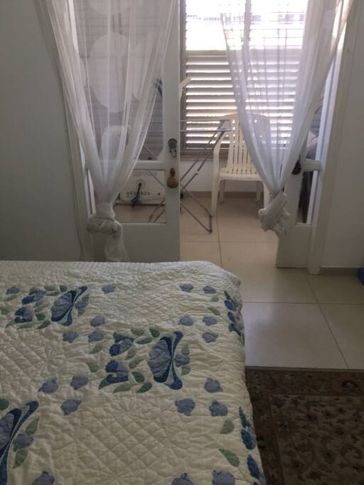 Guest bedroom with entrance to balcony