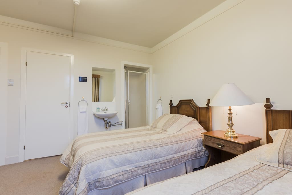 Private room with two comfortable single beds and private bathroom