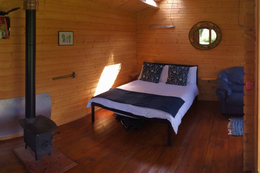 Spacious interior of one of the Huts. Full size double bed. Great wood burning stove for cooking and heating.......