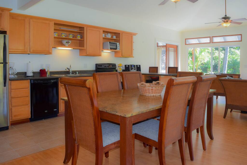 Enter into the great room, combining open kitchen, dining and living areas
