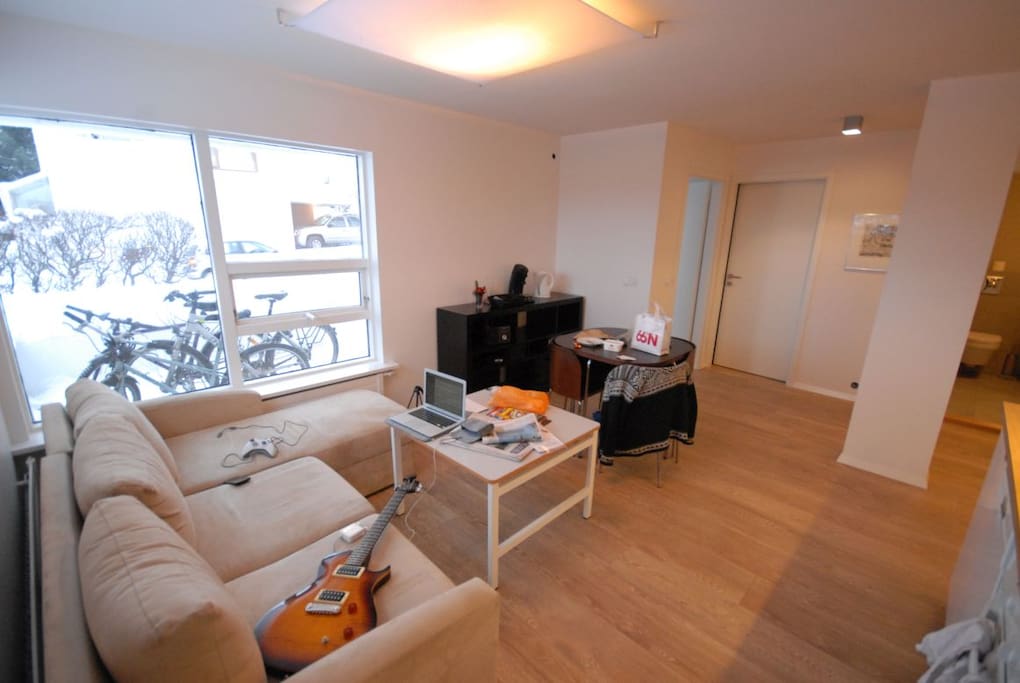 Livingroom/kitchen table. Window faces the entrance of the apartment. The bedroom door on right hand side.