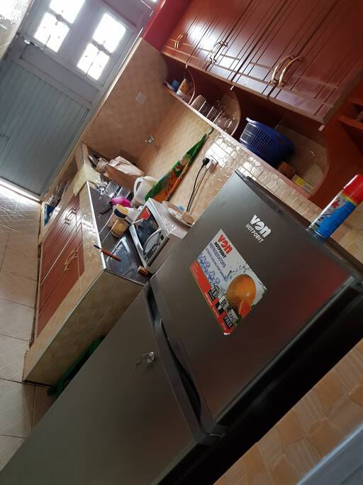 a kitchen with a sink, water and all utensils and cooking stuff.