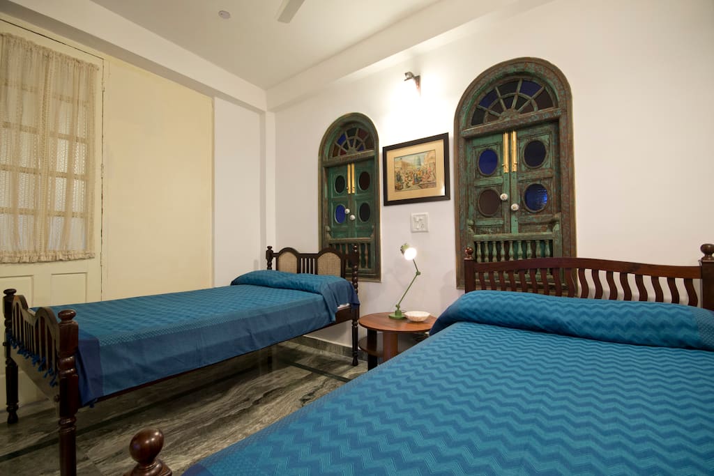 Antique twin beds in a large bedroom.