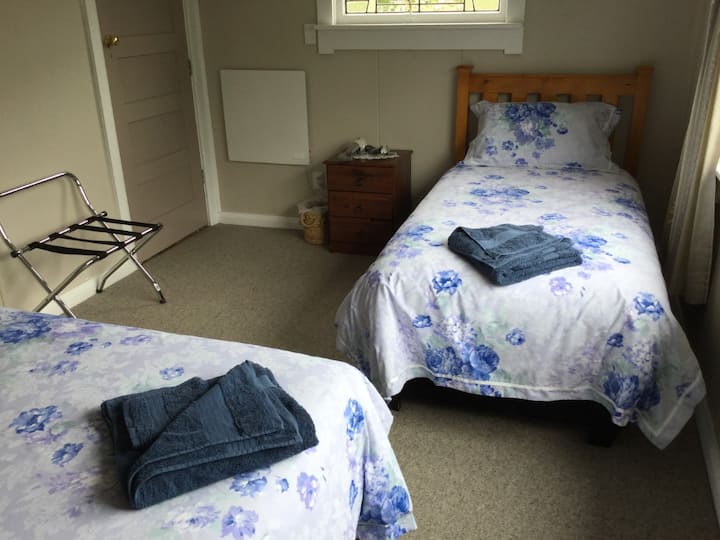 Bedroom 4 (accessed via bedrooms 2 and 3 but also has external access) - features 2 single beds (with electric blankets), two bedside tables and a bedside lamp. 