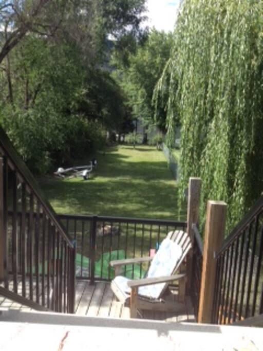 View from the deck. The home is on the lake but not right at the shore. There is a grassy space to play games before you reach the water