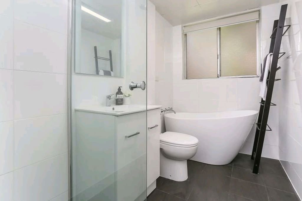 Bathroom with bathtub and shower