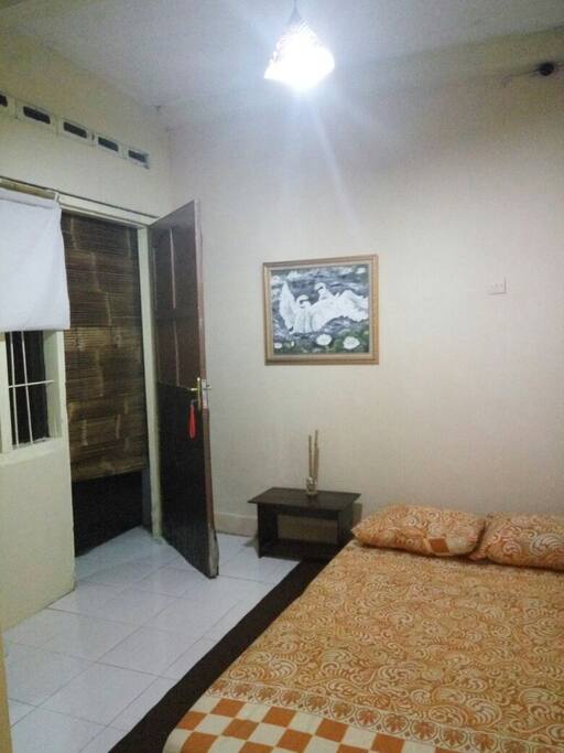 Double bed with fresh batik sheets