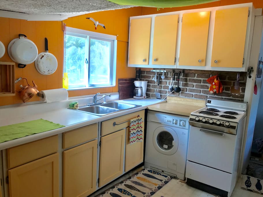 Kitchen with Stove, full size fridge and microwave.