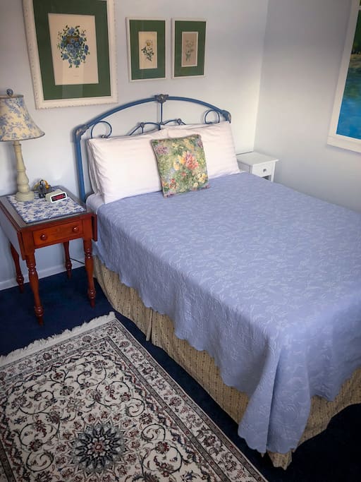 Our Monet Room. It has a comfy double bed. You can just see the edge of the wall mural on the right.