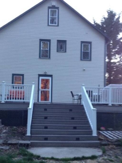 Large back deck equipped with gas grill and furniture