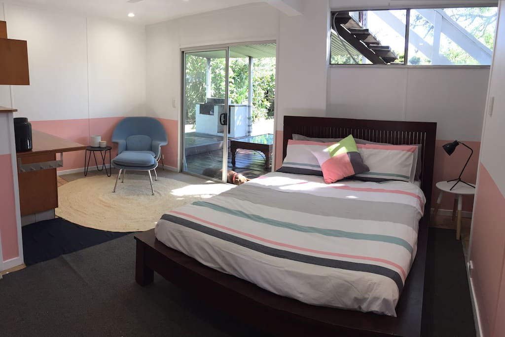 Large hotel style studio with ensuite and kitchenette, opening on to covered entertaining deck and BBQ area.