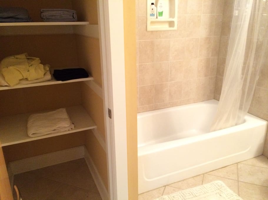Bathroom with much storage space, towels and toiletries provided