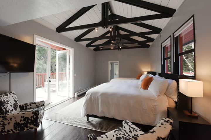 Upstairs master bedroom looks out to the canyon, trees and hills beyond.  Morning sun brightens the private deck.
