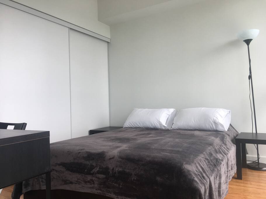The first bedroom! Wake up to a morning view right from the bedroom with our top to bottom glass window showcasing the beautiful view