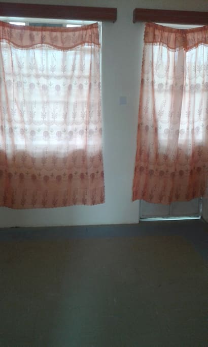 My spacious living room with orange curtains:)
