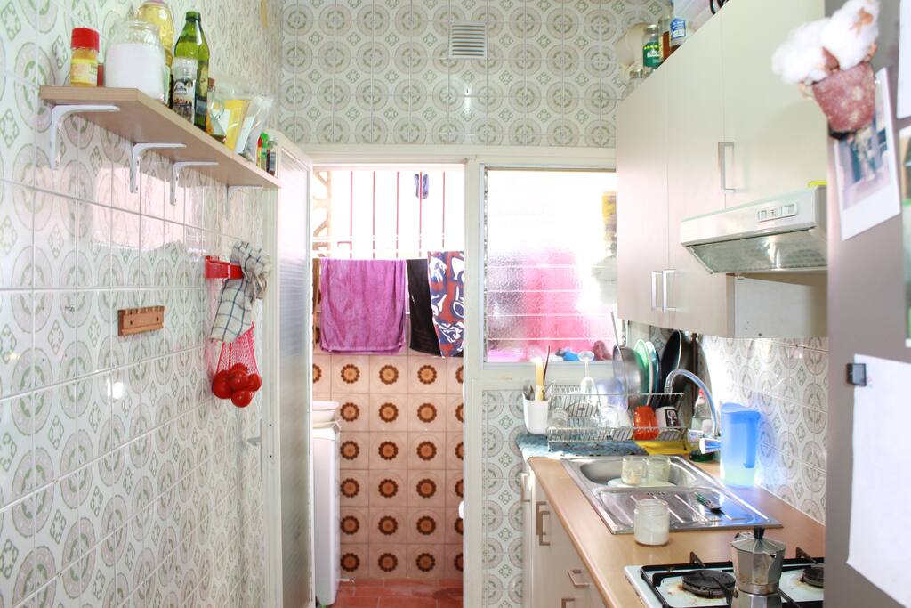 Cozy kitchen with access to the space of washing machine and drying rack