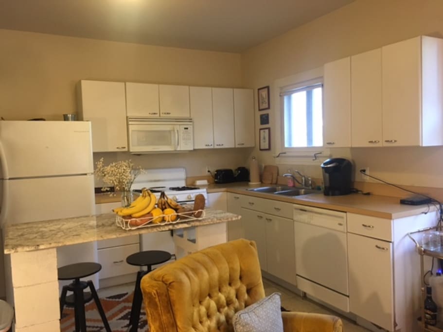 Fully-equipped kitchen that includes Keurig and Vitamix blender.
