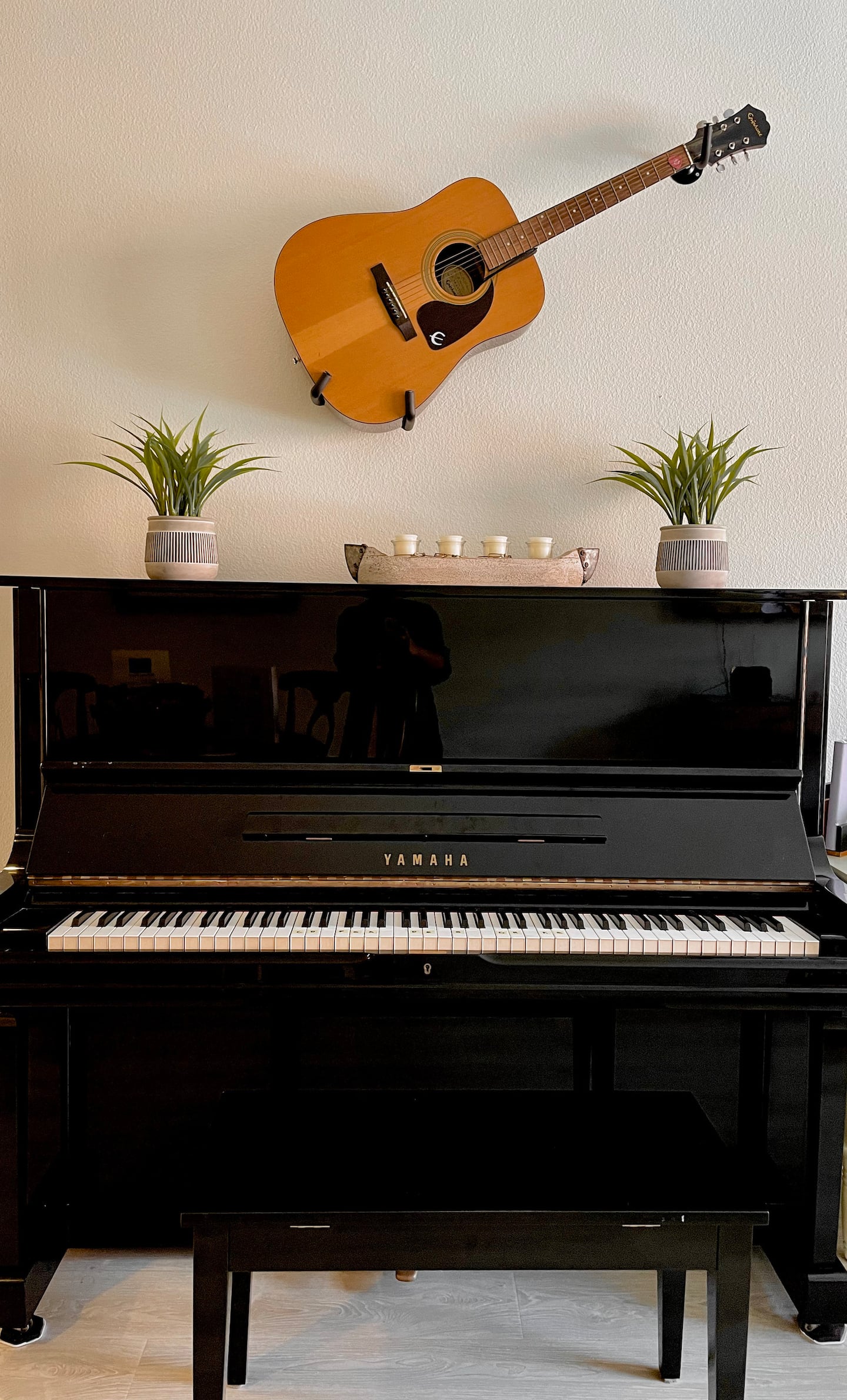 Yamaha upright piano, acoustic, and electric guitars available for guests.