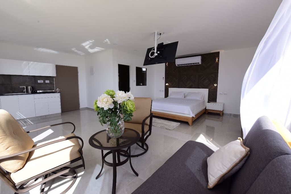 Open space bedroom, hi class smart TV, very useful kitchen with grill, microwave, electric stove, and electric coffee kettle.