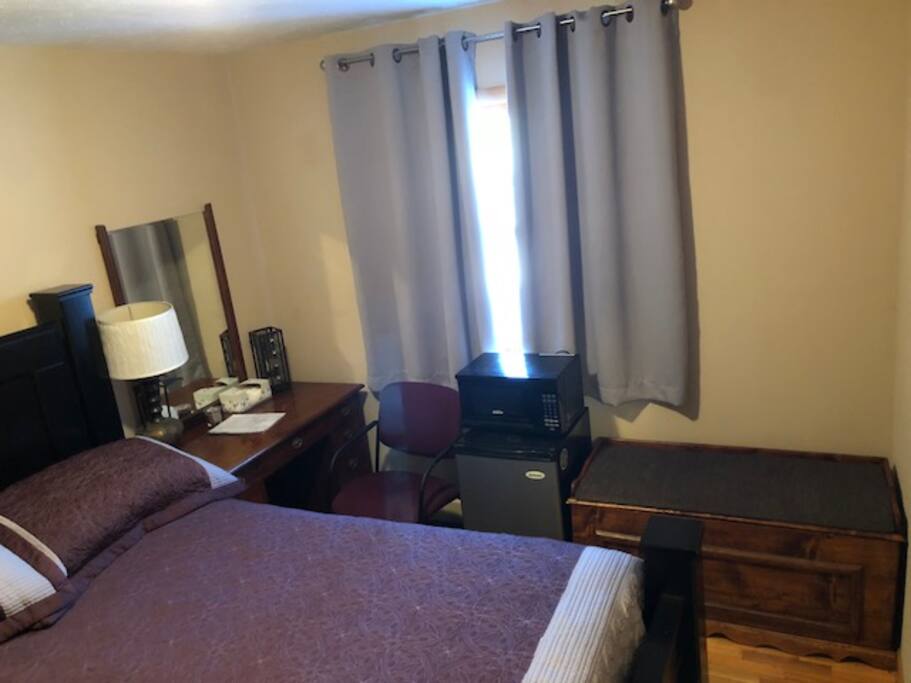 Microwave no longer available inside bedroom. However, microwave is available in shared kitchen. Guest Bedroom with mini fridge, microwave, desk/vanity and storage chest