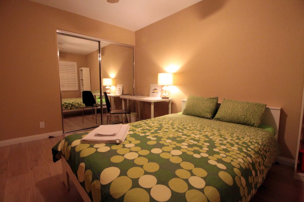 Guest bedroom sleeps two adults, with desk and chair