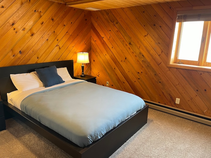 Bedroom 4 has a cozy queen sized bed with that authentic cabin feeling