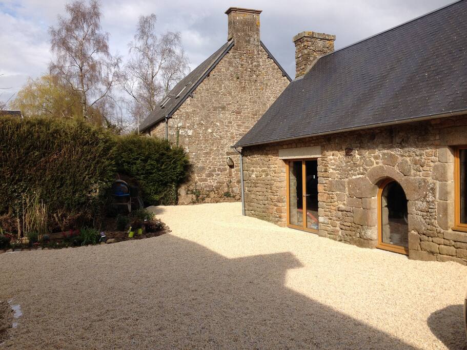 Sunny garden overlooking 16th century cottage under renovation.