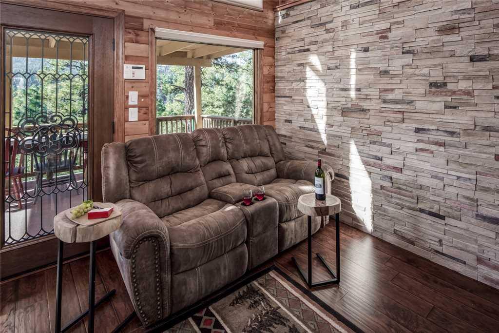 The living room is very bright and inviting, with plenty of space and high ceilings.