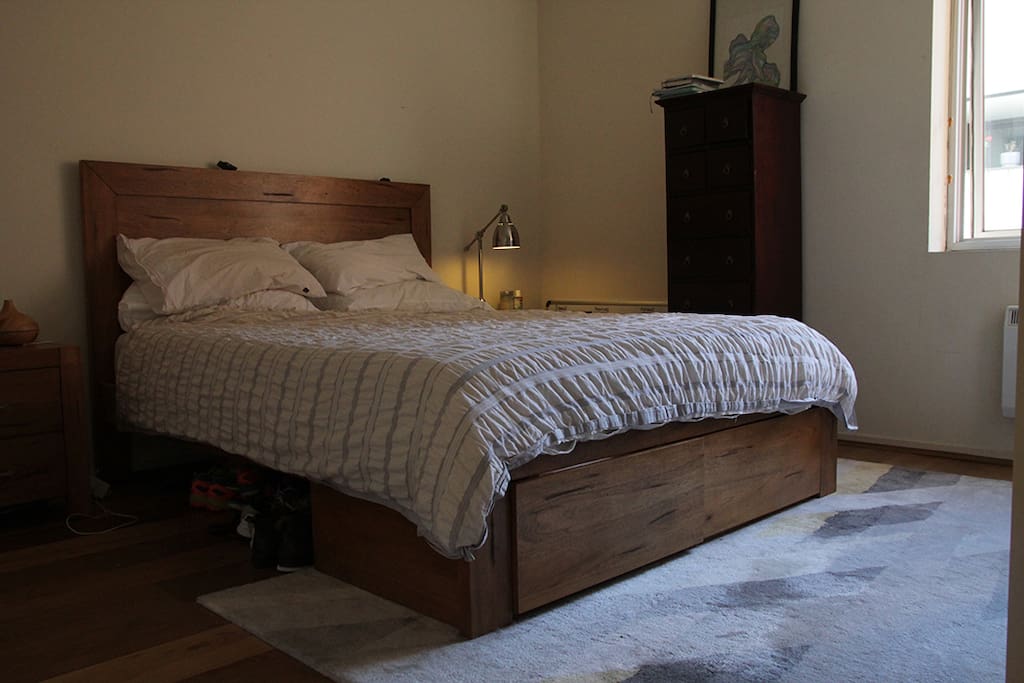 Bedroom with queen size bed and lots of natural light.