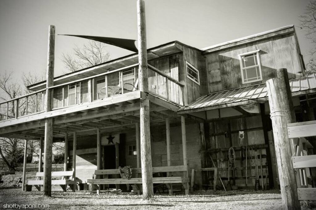 Barn tack and feed room below the bunkhouse. Private deck with awning overlooking peaceful pastoral views; bedroom is situated on the upper right, kitchen and living room on the left. Tons of natural light.