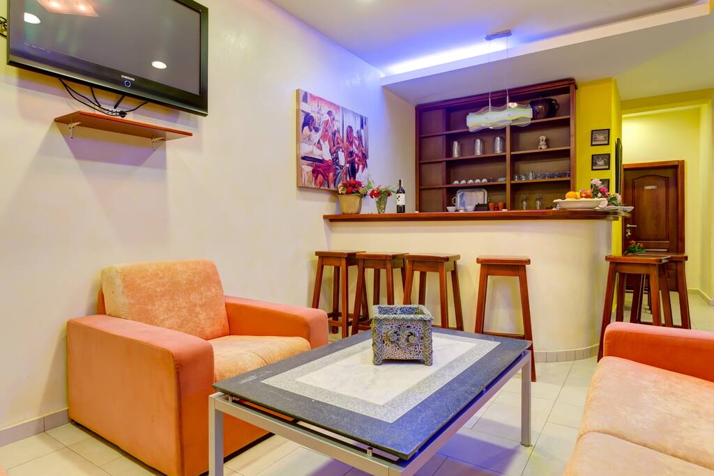 Corner which is equipped with a bar and a small kitchen.
