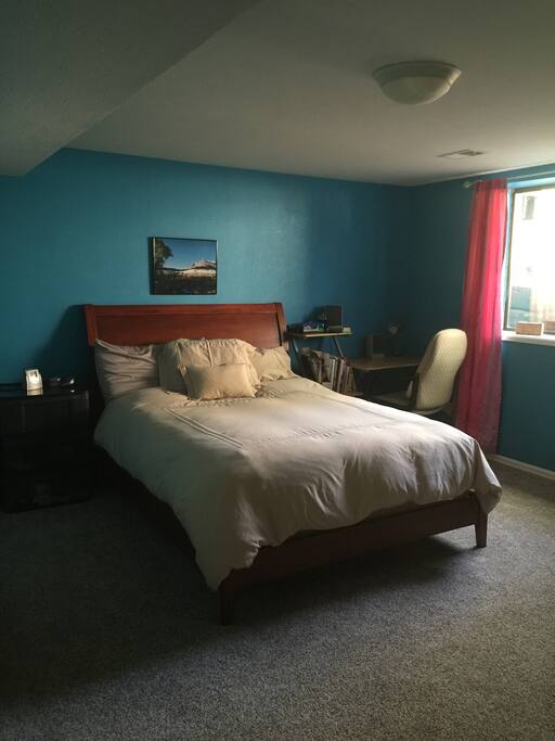 Private bedroom with queen bed, desk and dresser for guest use