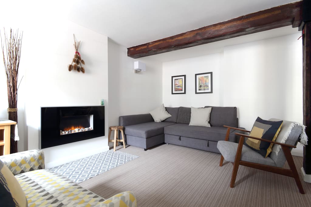 Lounge with original beams and flame effect fire