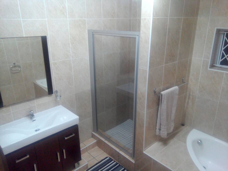 Bathroom: shower with large shower head, large mirror, fresh towels daily