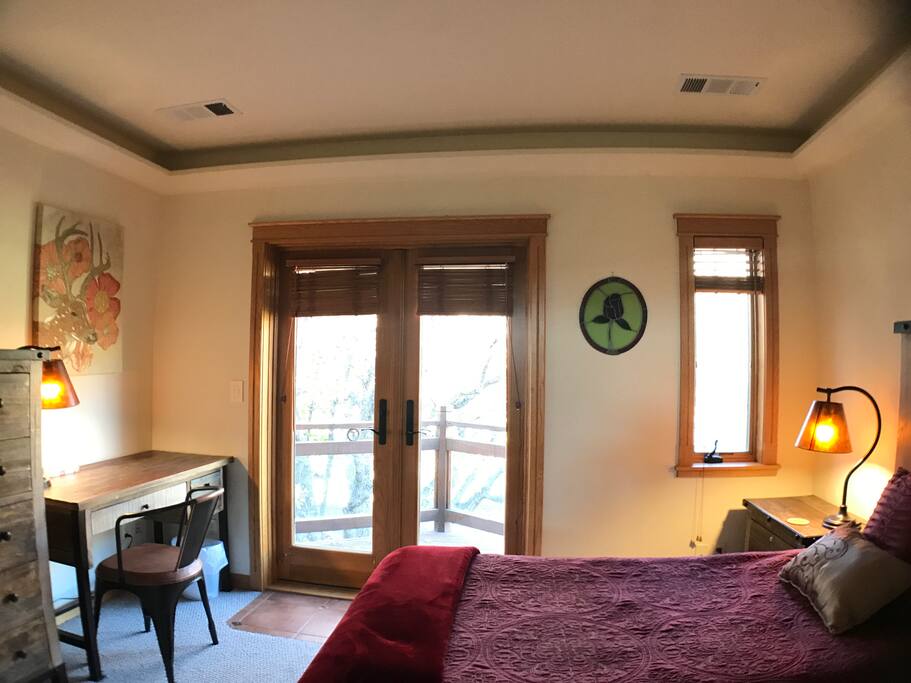 The warm red tones of this room welcome you to relax or write in your journal at the warmly lit desk.