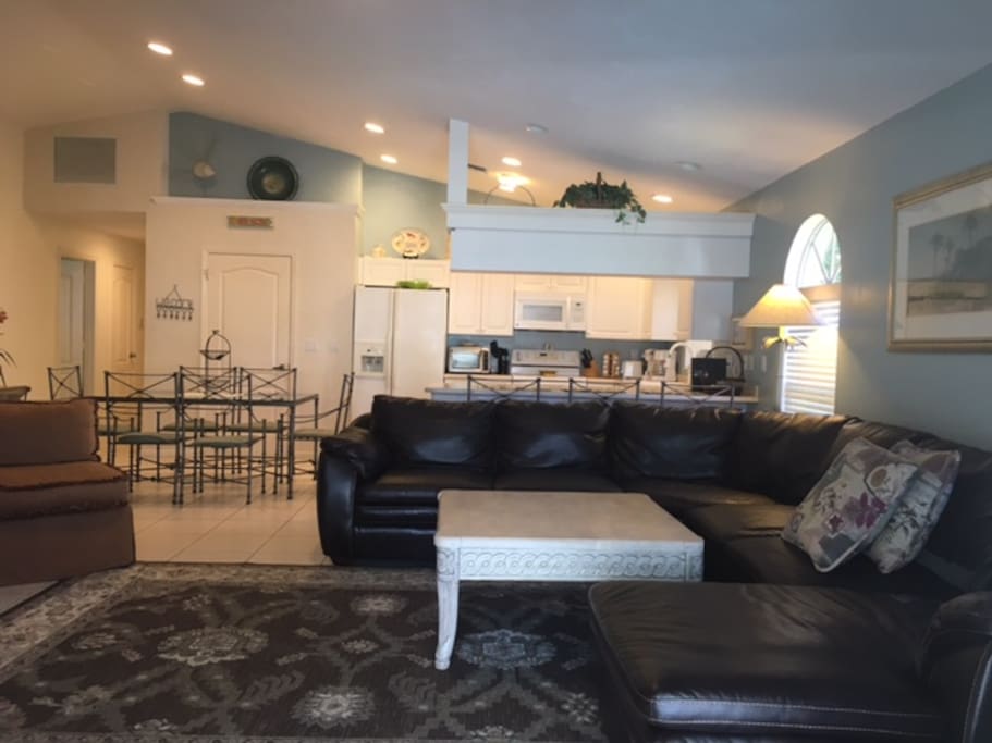 Open Living room with French door leading to Pool/Deck area
