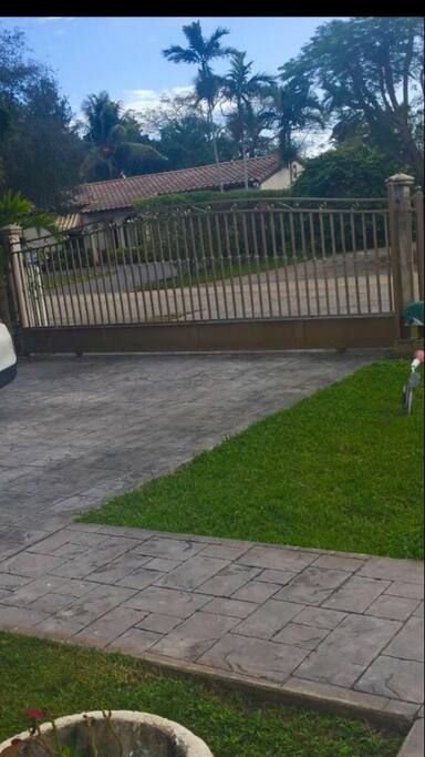 Front of the house . Free parking . Open parking . The house is gated it and protected . Bus stop next to the house