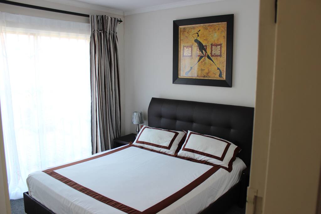 Main bedroom with sliding door to a patio