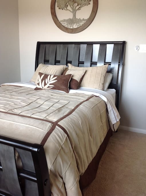 Guest Room #1, has queen bed, closet with hangers.